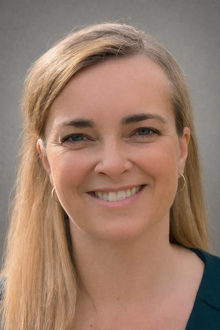 Camilla Riis Petersen, a woman with long blond hair and blue eyes, smiles into the camera. 
